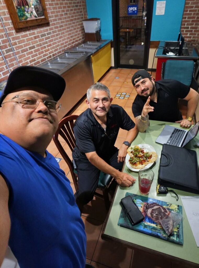 Jesse with guests at their table during trivia night