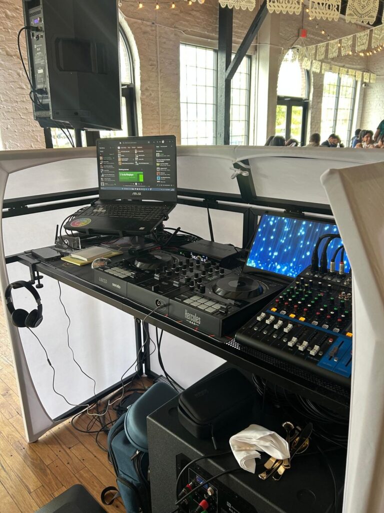 Close-up of the DJ controller, mixer and laptop at a wedding
